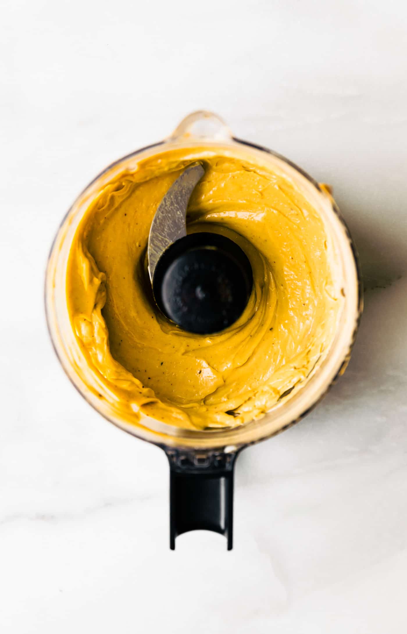 Overhead view homemade chipotle mayo in food processor bowl