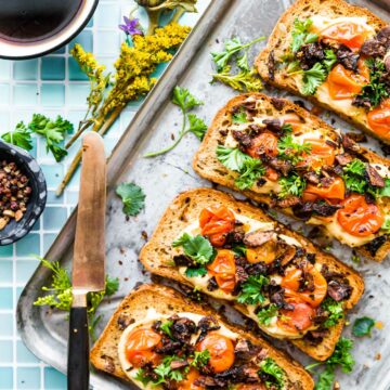 Mushroom Bacon Breakfast Toast is a plant-based, gluten-free breakfast recipe that will transform the way you think of toast! A vegan bacon substitute, made from smoky mushrooms, sits on a bed of hummus with tomato and fresh herbs. This healthy hummus toast is full of protein, fiber, and flavor.  #breakfastrecipes #hummustoast #veganbacon