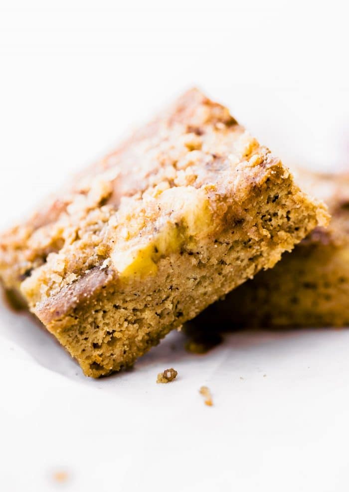 Side view of banana bread bars cut into squares, propped up on another bar.