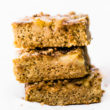 Flourless banana bread bars cut into squares, stacked up on each other.