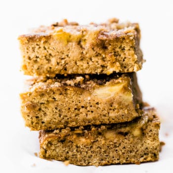 Flourless banana bread bars cut into squares, stacked up on each other.