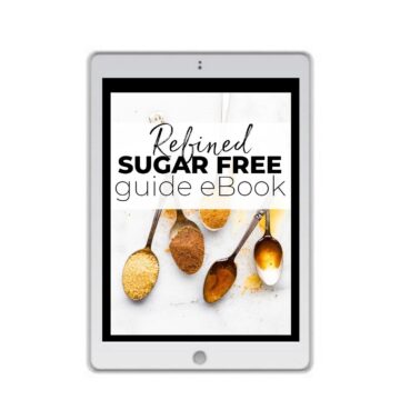 White iPad with picture of spoons full of sugar on screen. Title across the spoons reads "refined sugar free guide eBook" title