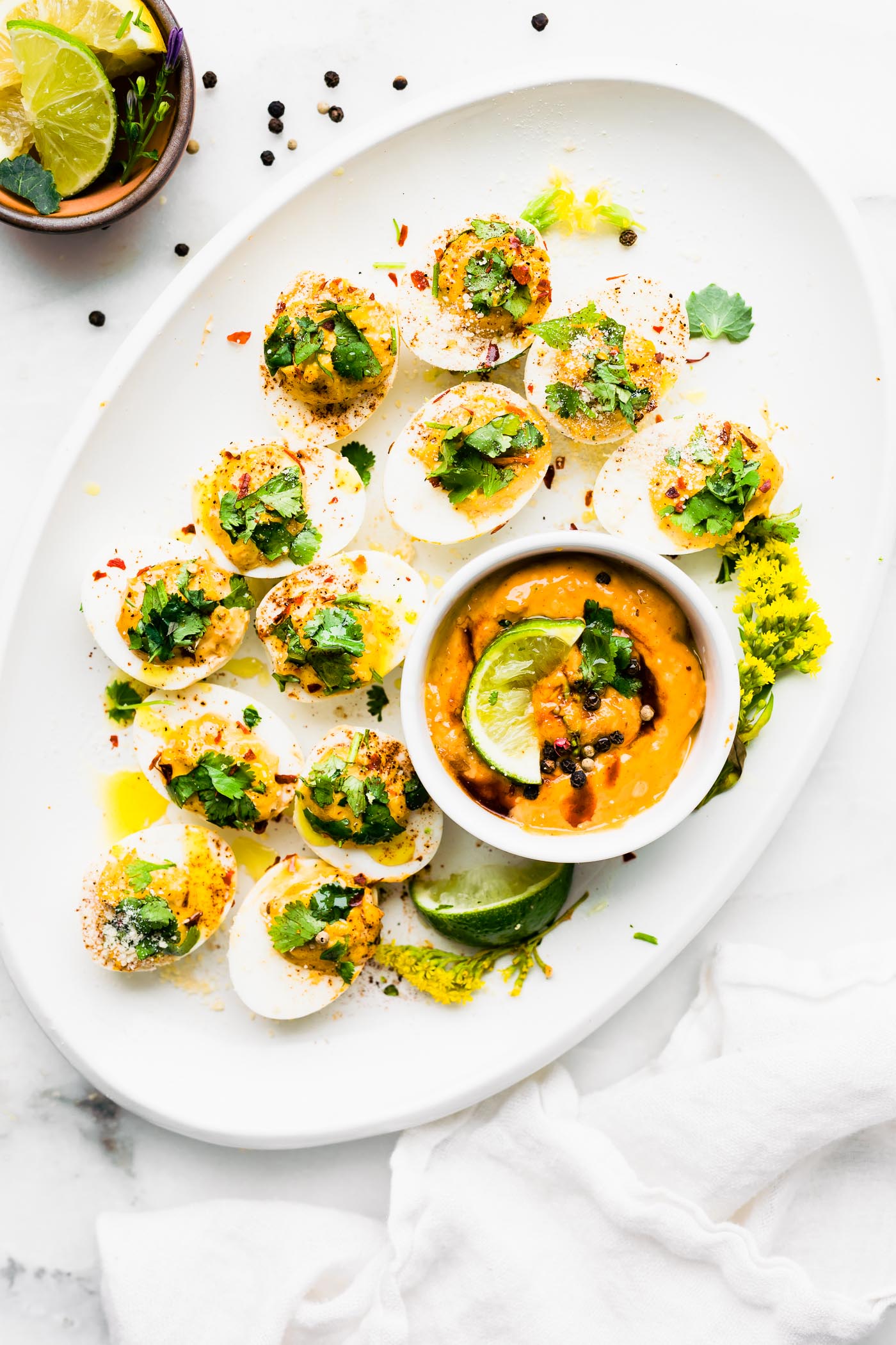 White platter filled with deviled eggs filled with chipotle mayo filling