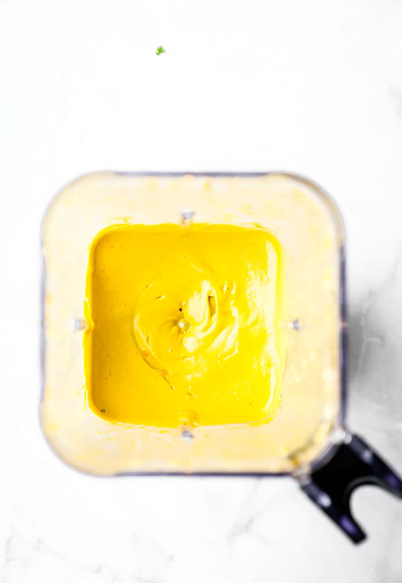 Overhead view ginger curry sauce in high speed blender cup