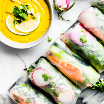 platter of vegan spring rolls with curry dipping sauce