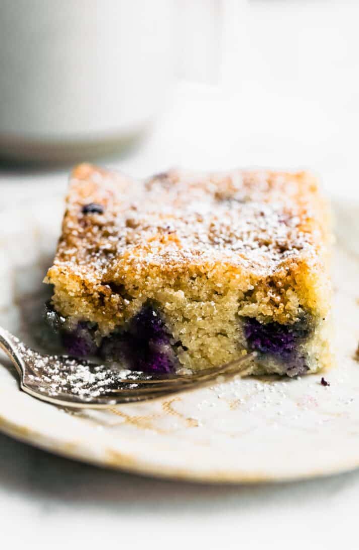 squares of blueberry buckle cake on white plate.