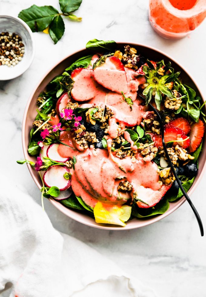 Overhead view Spinach Strawberry Salad in pink bowl,