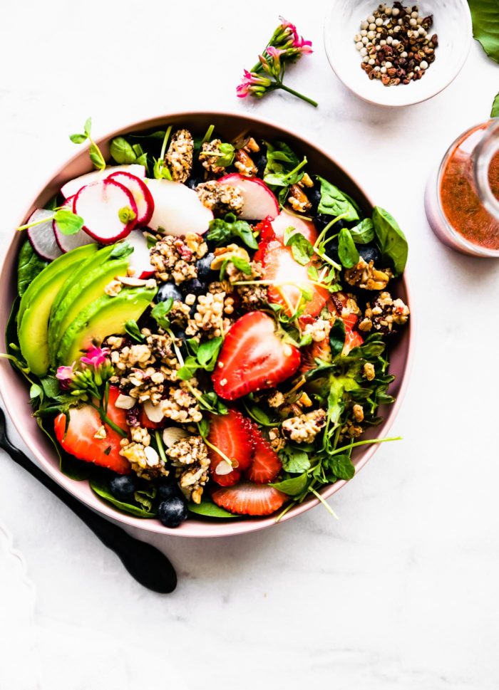 overhead image: strawberry spinach salad with granola croutons