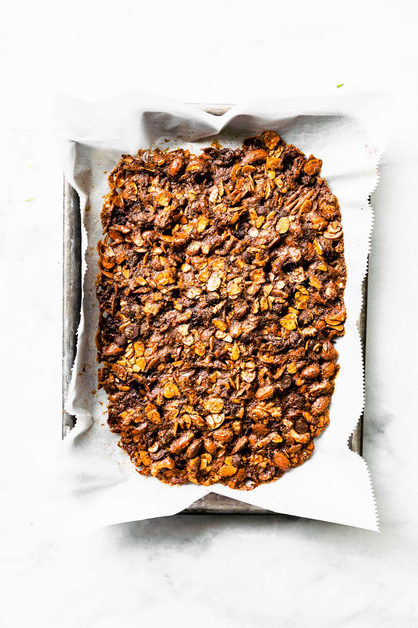 grain free baked granola on parchment paper lined cookie sheet