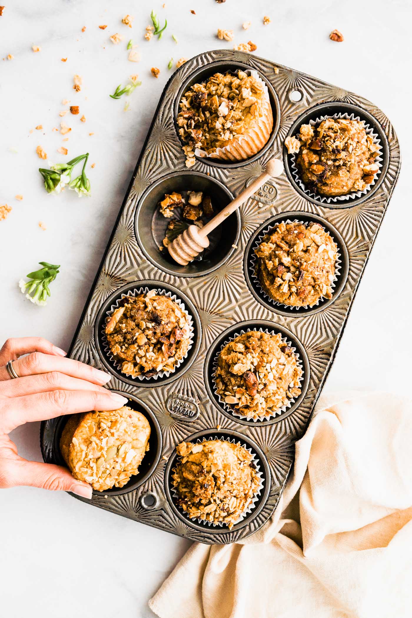 Six-count muffin pan filled with breakfast muffins topped with crumble, one muffin removed.