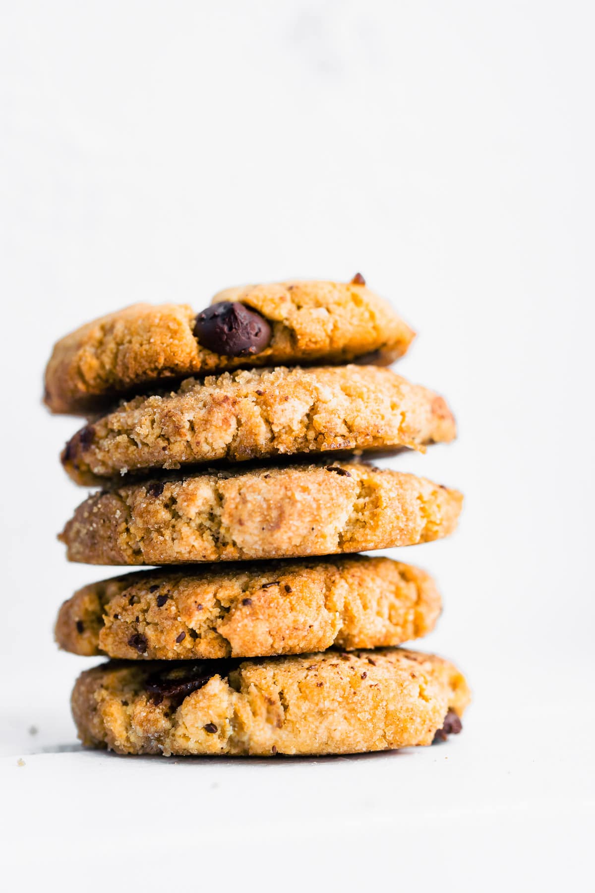 tall stack of homemade almond flour cookies with chocolate chips.