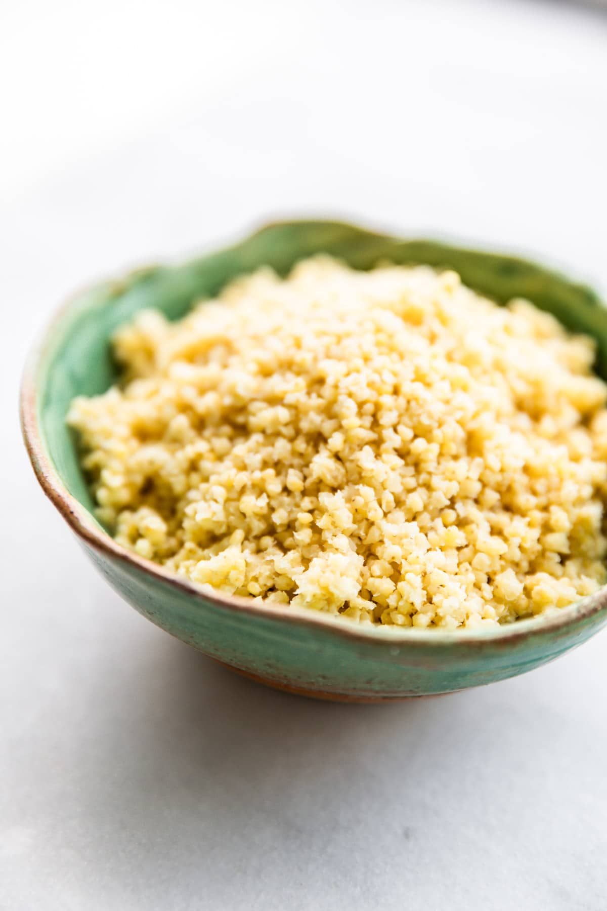 cooked millet in turquoise bowl