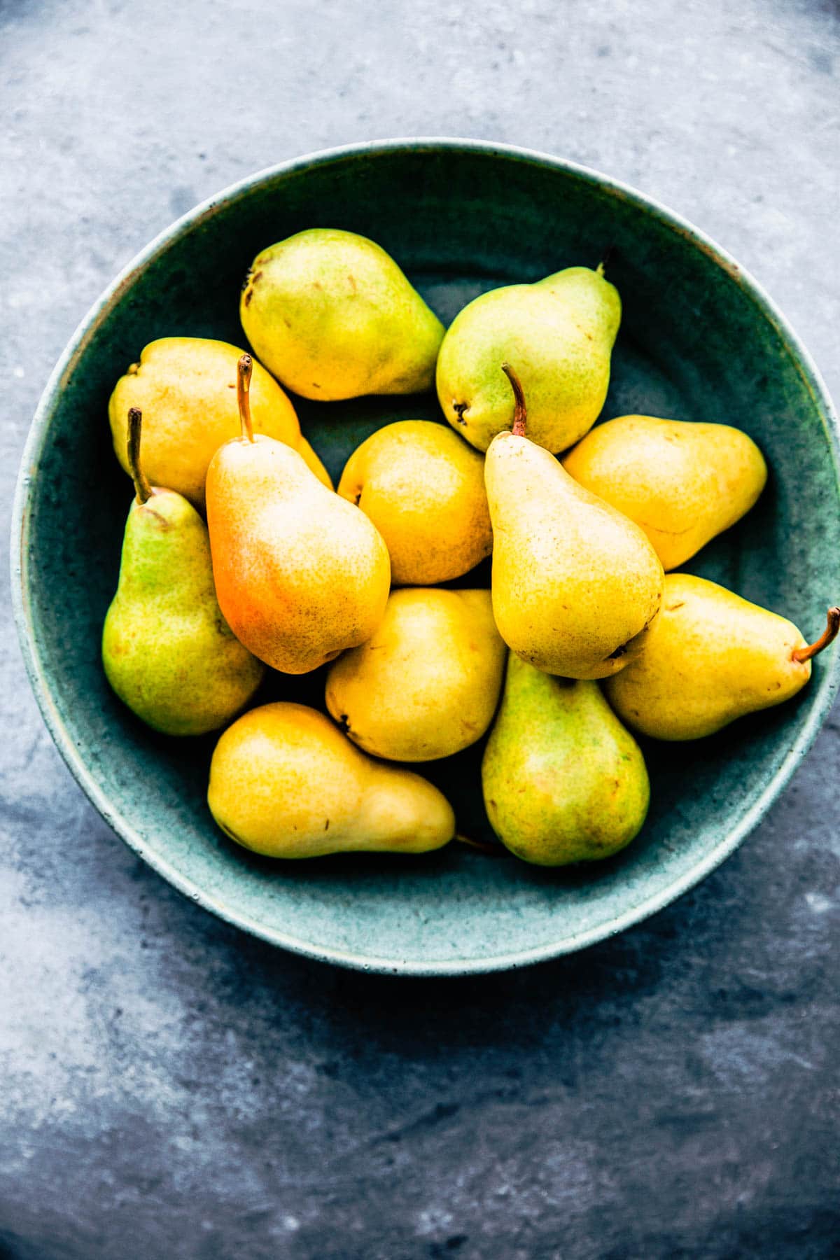 Fresh pears in turquoise bowl