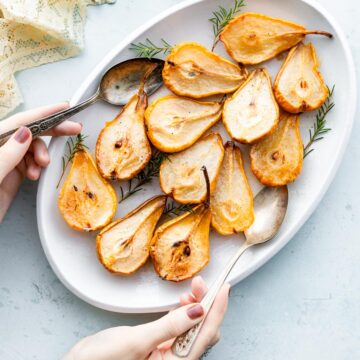 baked pears with maple bourbon glaze on white platter