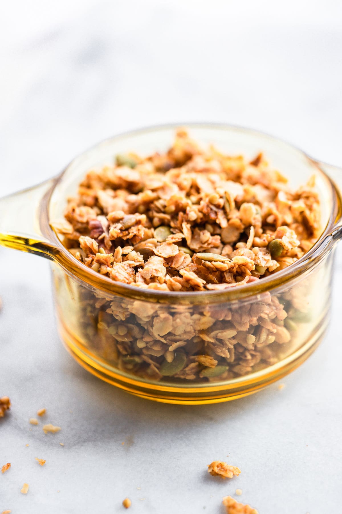 Homemade Maple Buckwheat Granola with pepita seeds in a clear brown bowl