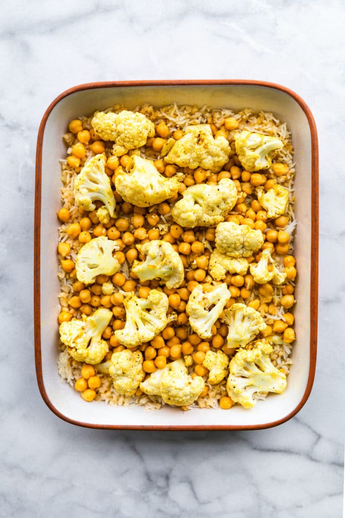 Vegan meal prep made quick, easy and nutritious with this recipe for Curried Chickpea Cauliflower Bake. There are only 5 simple ingredients in this cauliflower casserole, but the flavor combination is out of this world delicious! It's a hearty dinner that's full of protein and fiber. Plus, it's gluten free, and there's a lower carb option, too. #vegan #mealprep #dinner #glutenfree #vegetarian #lowcarb