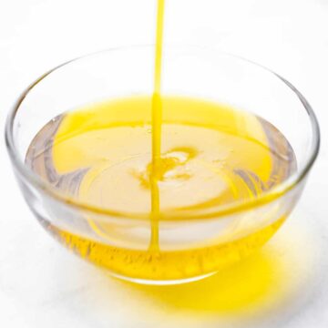 olive oil streaming into glass bowl
