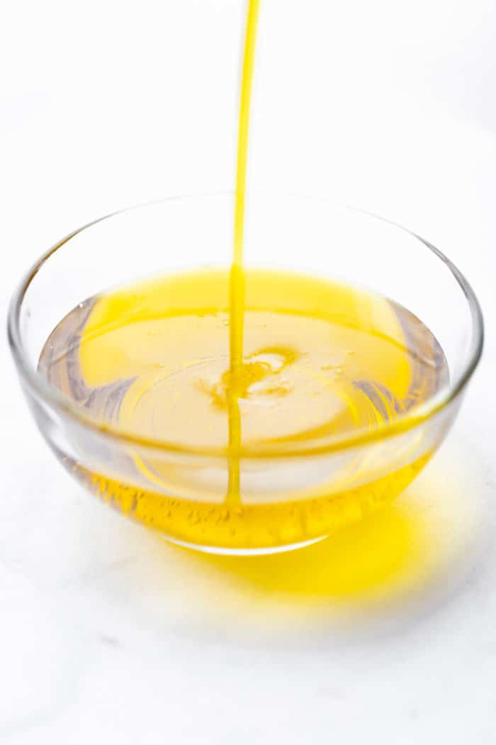 olive oil streaming into small glass bowl