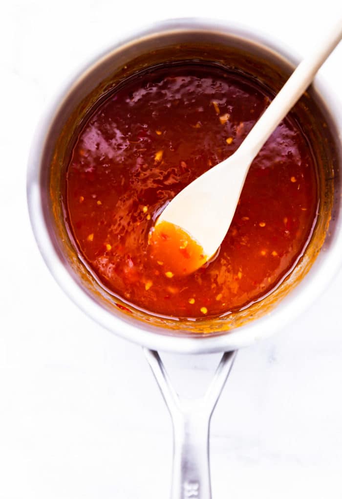 sweet and sour sauce in pan with spoon