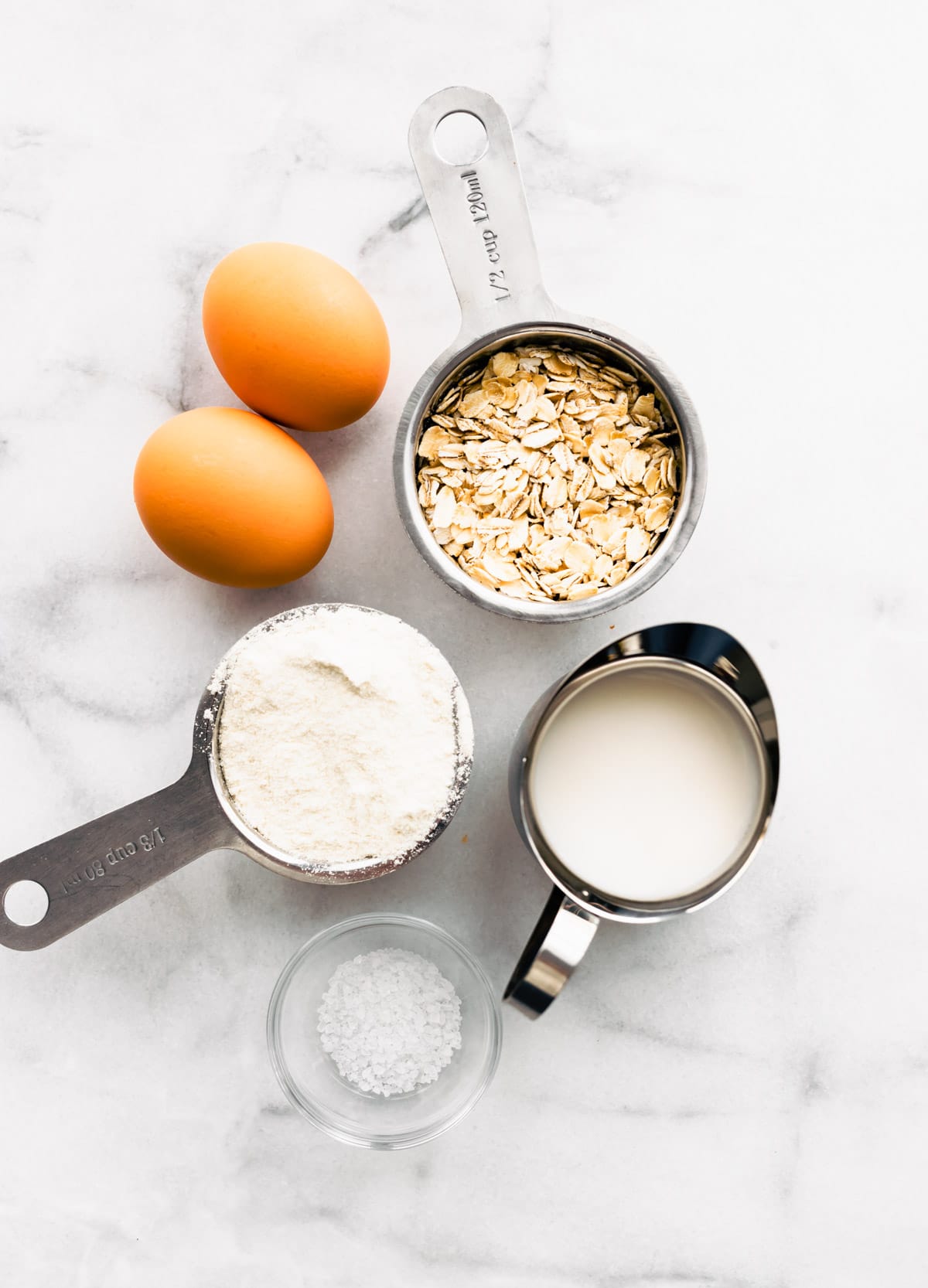 Ingredients for oatmeal crepes made with an egg arranged together.