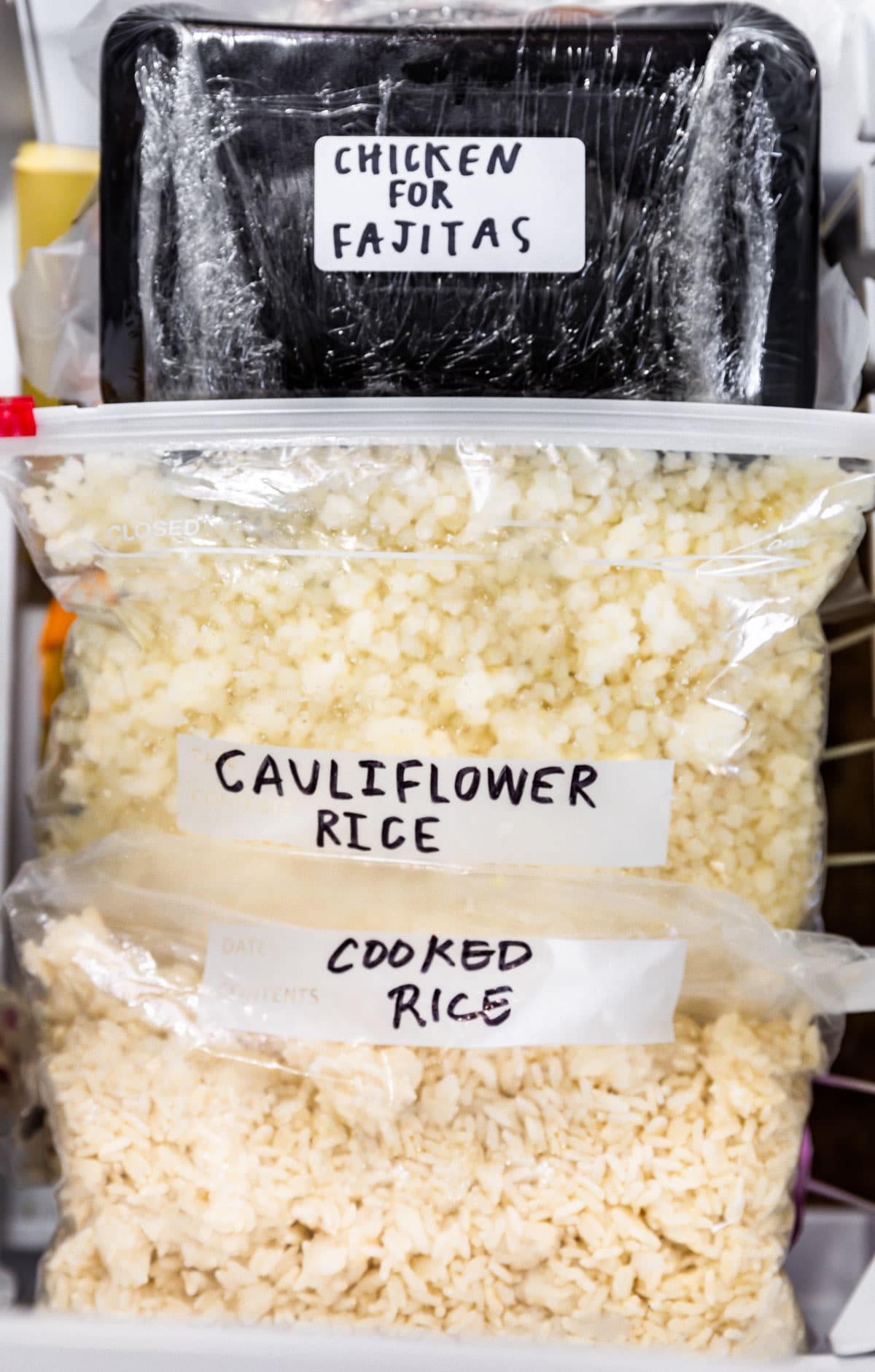 Frozen cauliflower rice in ziplock bag in a freezer.