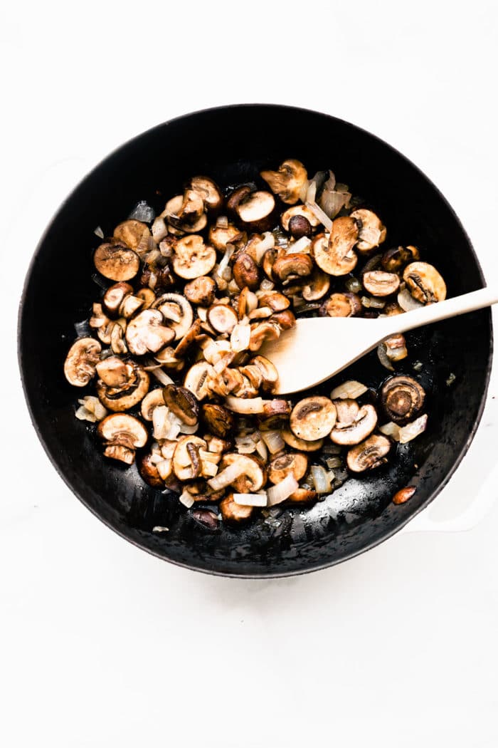 Overhead view skillet with sautéing mushrooms for vegan mushroom meatballs