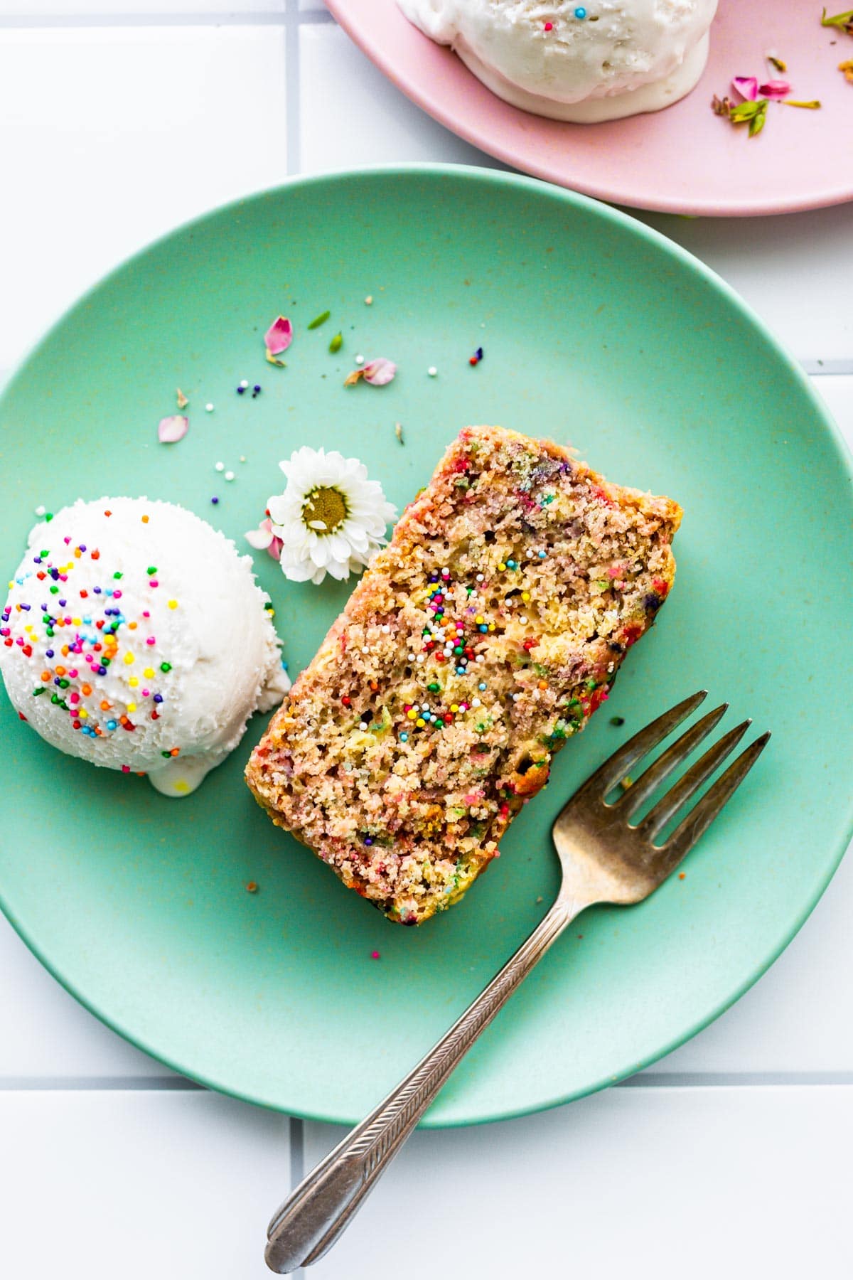 ice cream bread with colored sprinkles on mint green plate with a fork