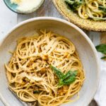 overhead photo shows bowl of tender pasta with vegan garlic sauce