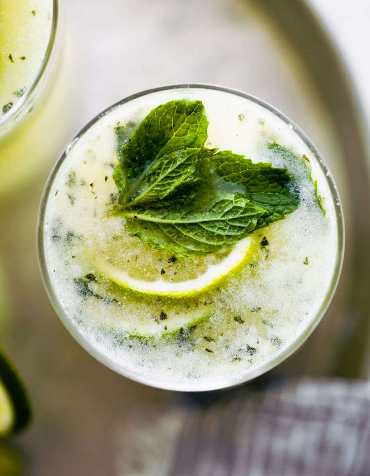 overhead photo of Brazilian limeade in glass garnished with fresh mint and lime slices