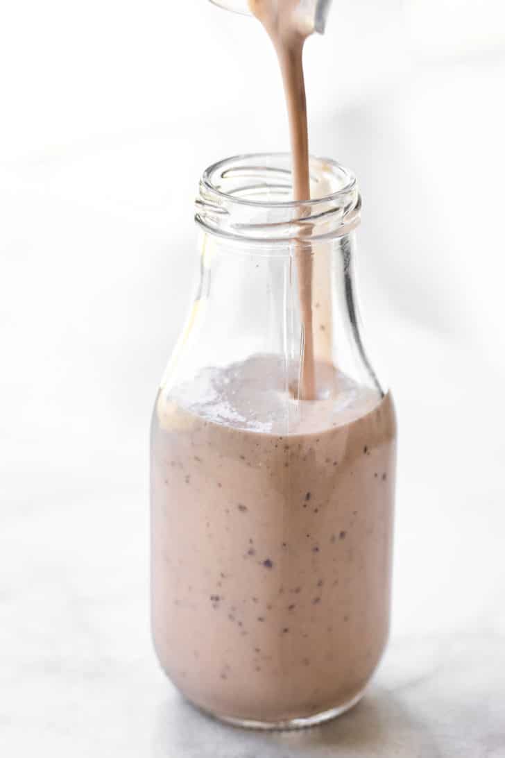 non-dairy milk, frozen bananas, frozen grapes, non-dairy yogurt, and chia seeds in a glass jar to make a frozen grape smoothie recipe