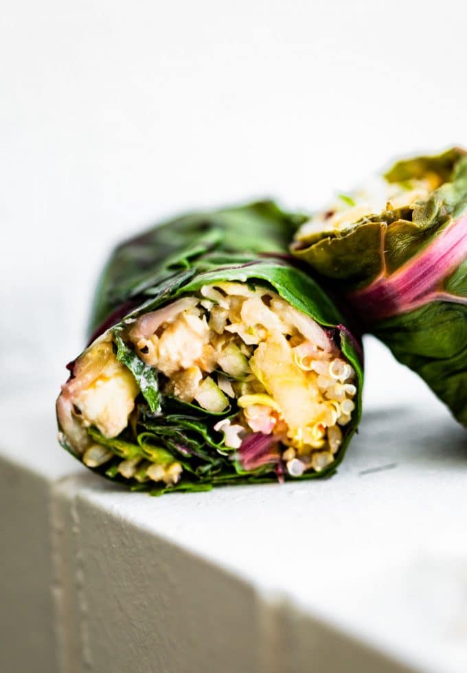 side view shows vegetarian filling inside of Swiss chard salad wraps