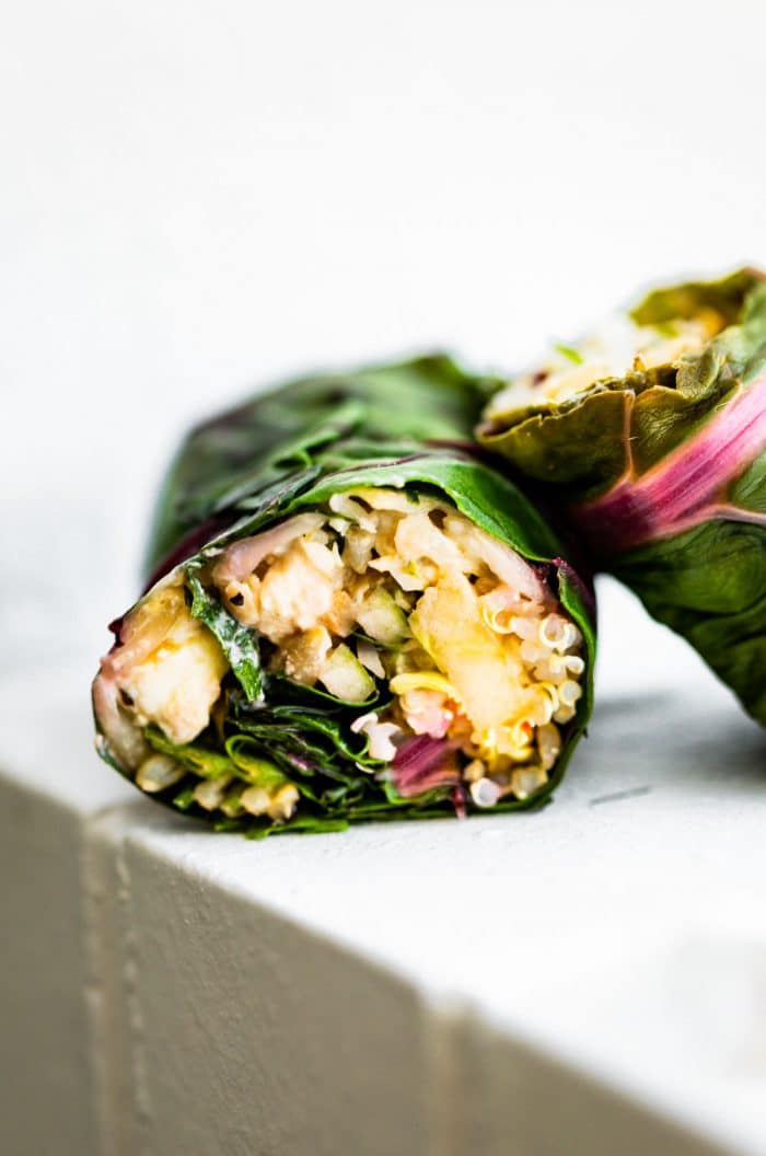 side view shows vegetarian filling inside of Swiss chard salad wraps