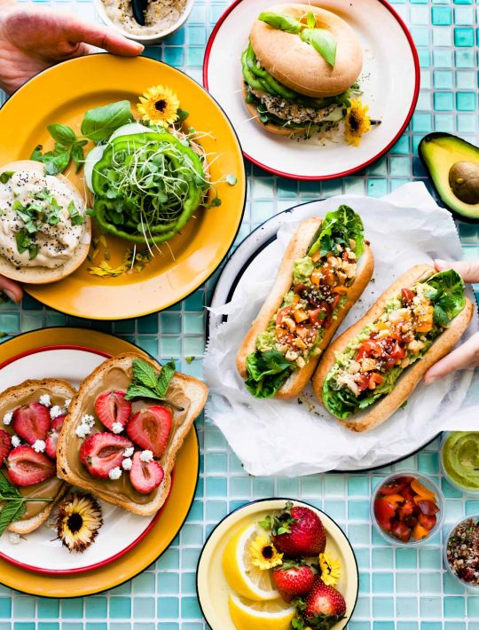 3 vegan sandwiches on colorful plates
