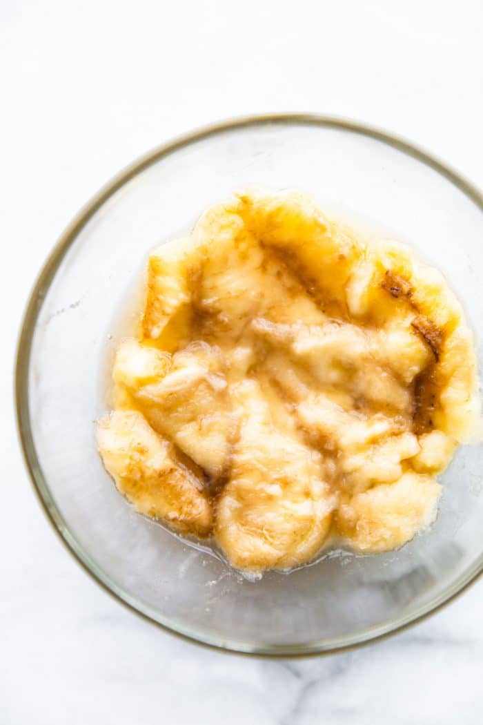 overhead photo: mashed banana in glass bowl