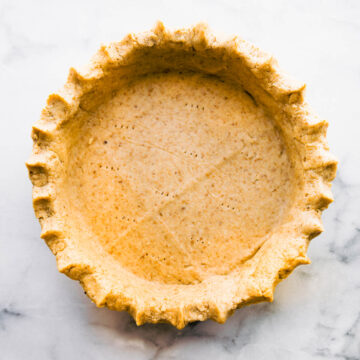 Overhead photo of homemade gluten free pie crust on gray background.