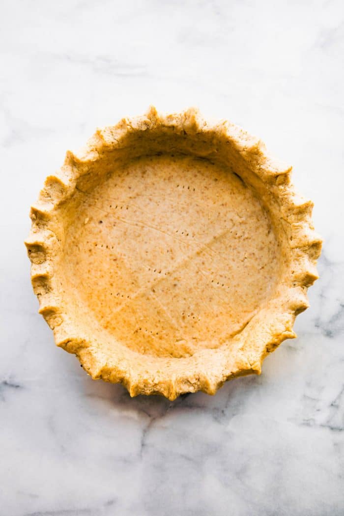 overhead: homemade gluten free pie crust on gray background