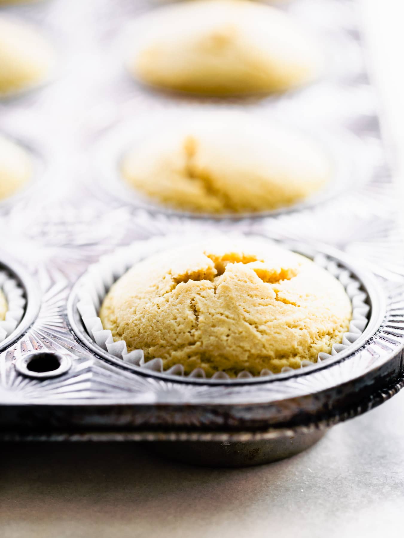 closeup of vegan vanilla cupcake in muffin pan