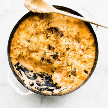 overhead photo: cauliflower mac and cheese casserole with one serving removed