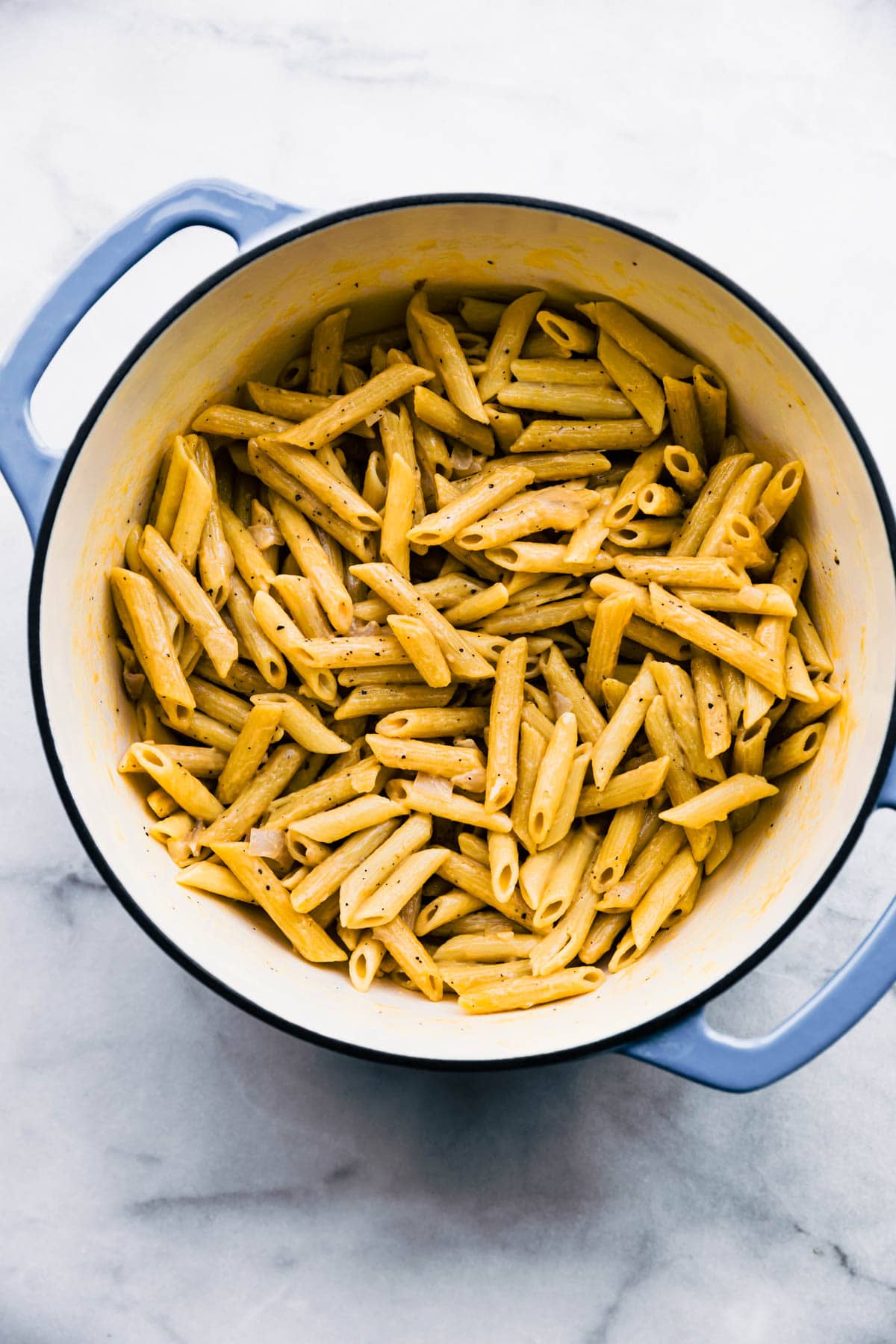 overhead image: gluten free pasta in large light blue soup pot