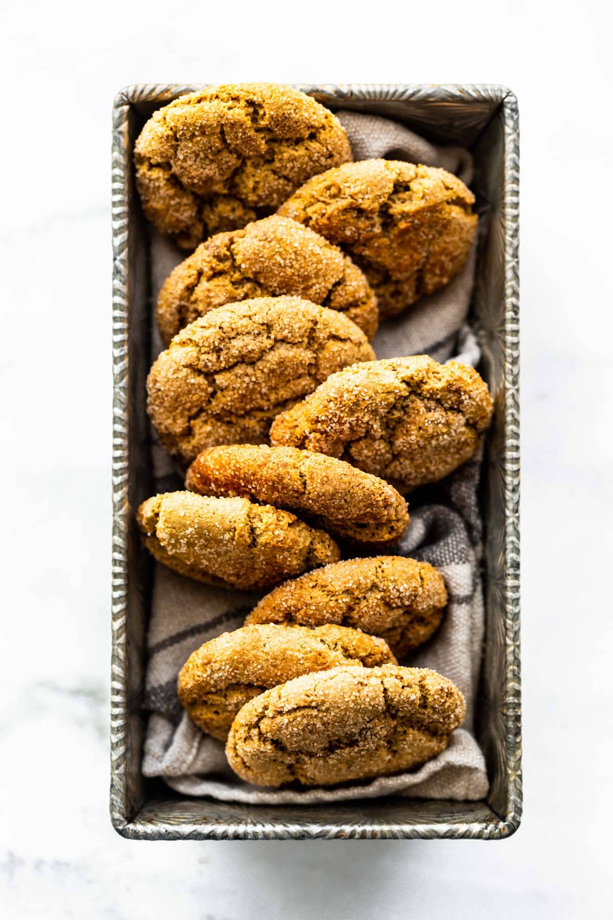 overhead photo: homemade brown butter gluten free snickerdoodles nestled in a loaf pan