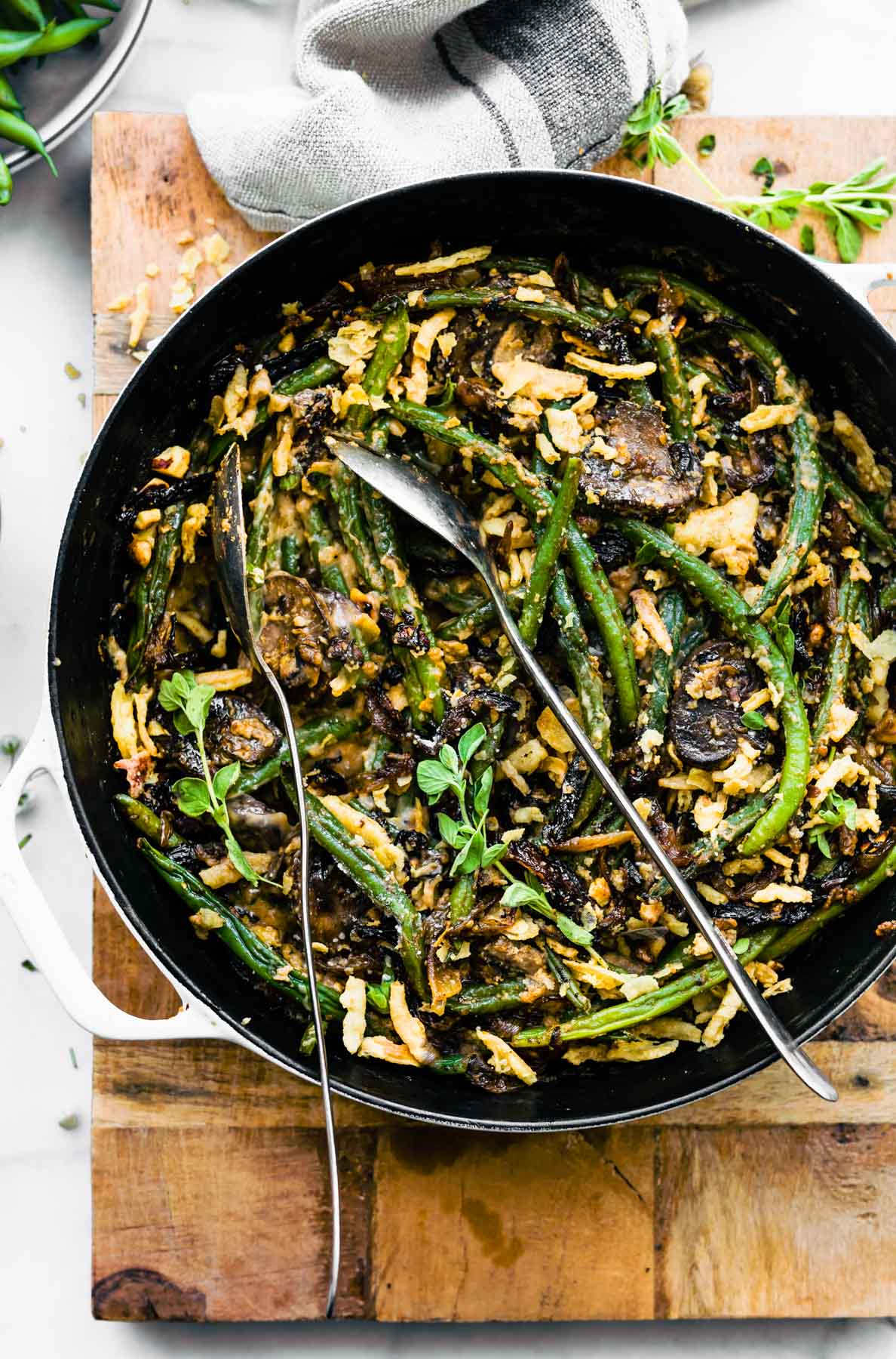 overhead image: dairy free green bean casserole in braising pot or baking dish