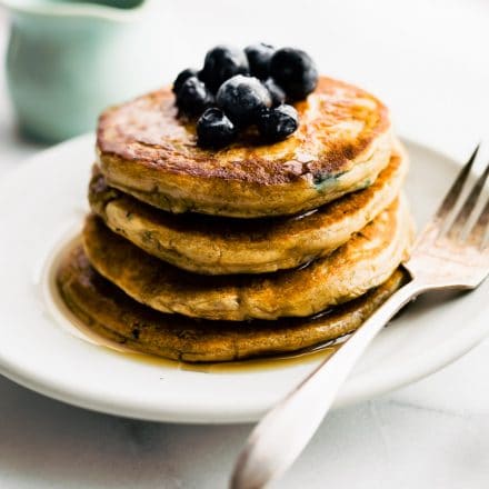 a stack of dairy free pancakes topped with fresh berries