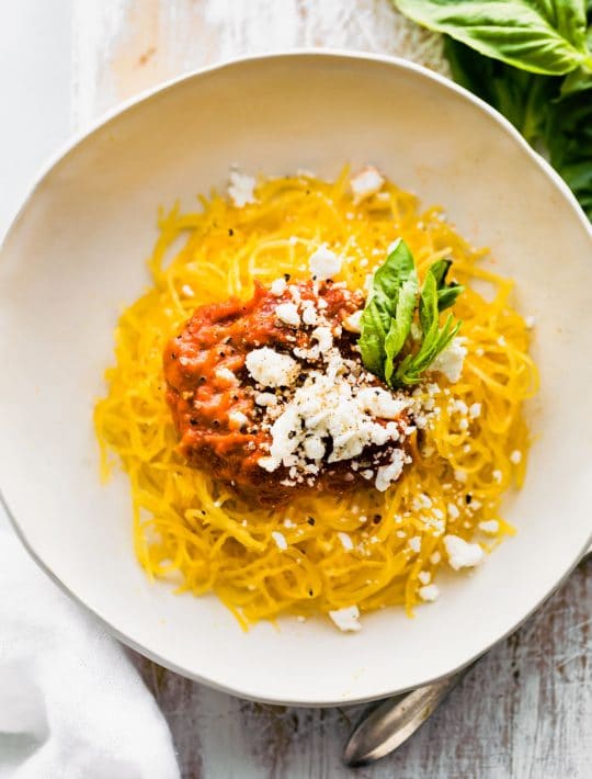 plate of Instant Pot spaghetti squash pasta with nomato sauce and dairy free Parmesan cheese
