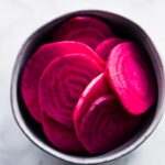 overhead image: slices of red beets in a small bowl