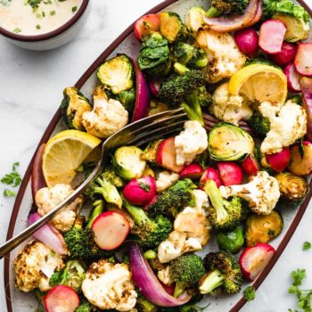 snack platter of healthy roasted vegetables next to dish of vegan ranch dressing