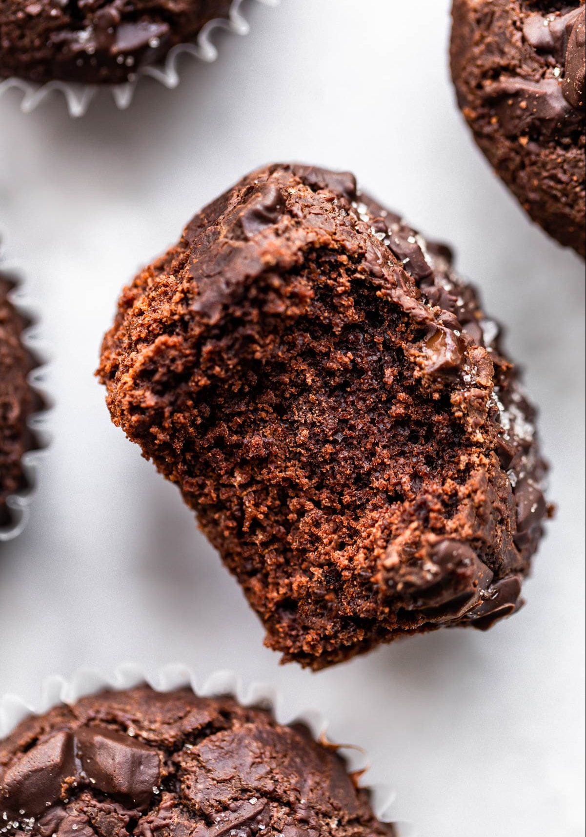 overhead image of a vegan chocolate muffin with bite taken out