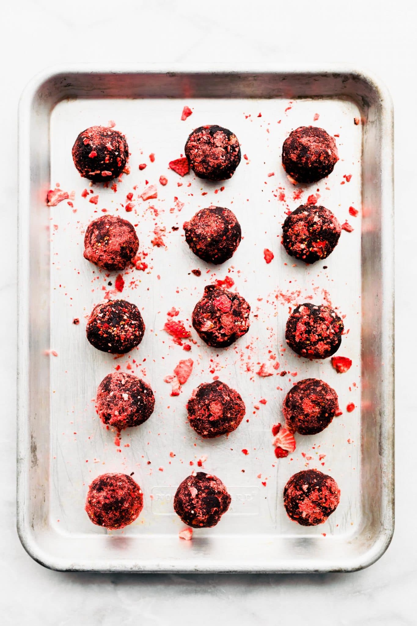 chocolate covered strawberry brownie bites on baking sheet