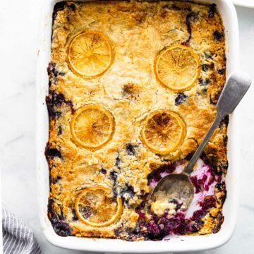 Overhead image: Cooked lemon blueberry cake in baking dish