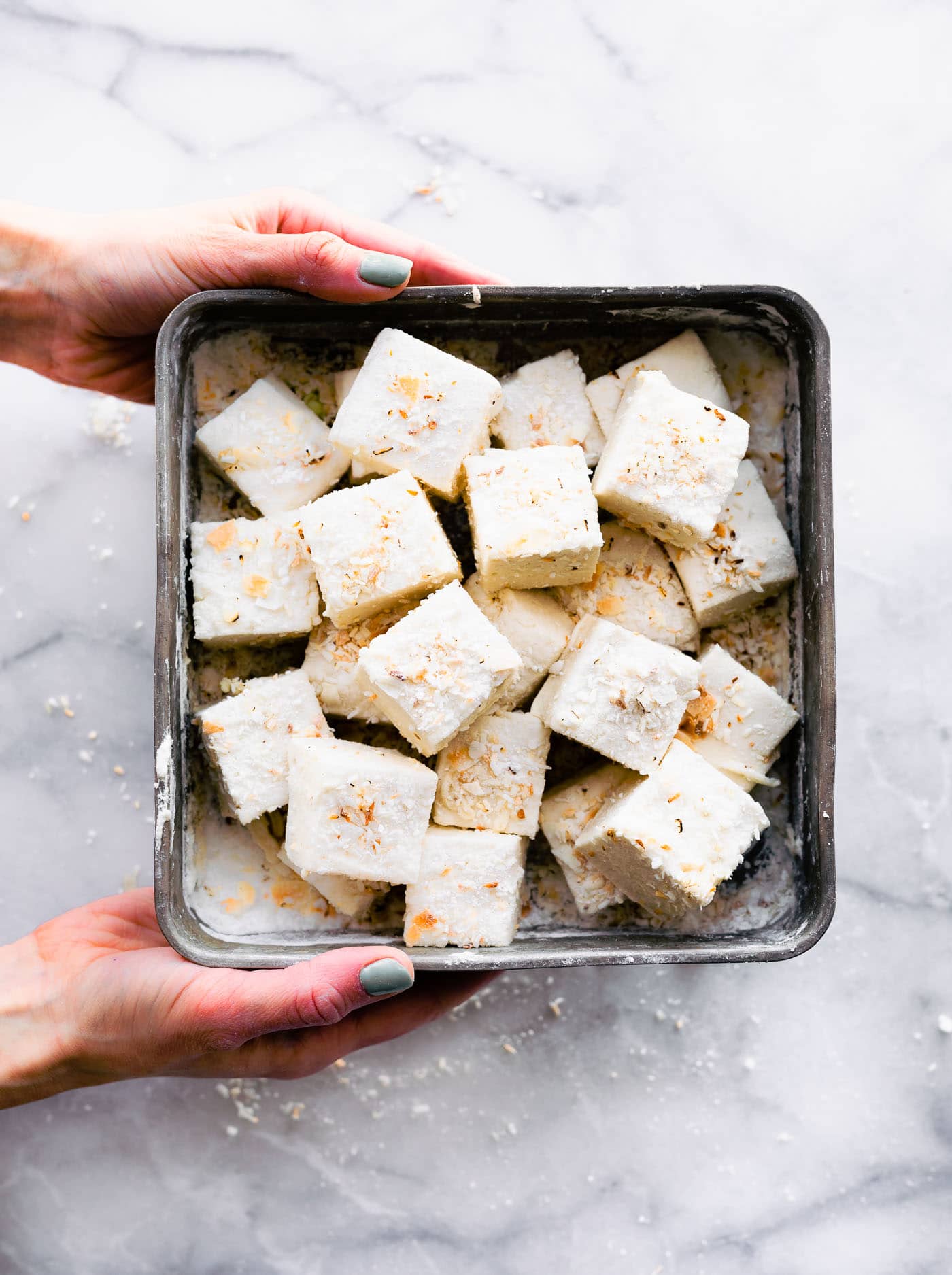 An overhead image of homemade marshmallows cut and tossed into the baking dish.