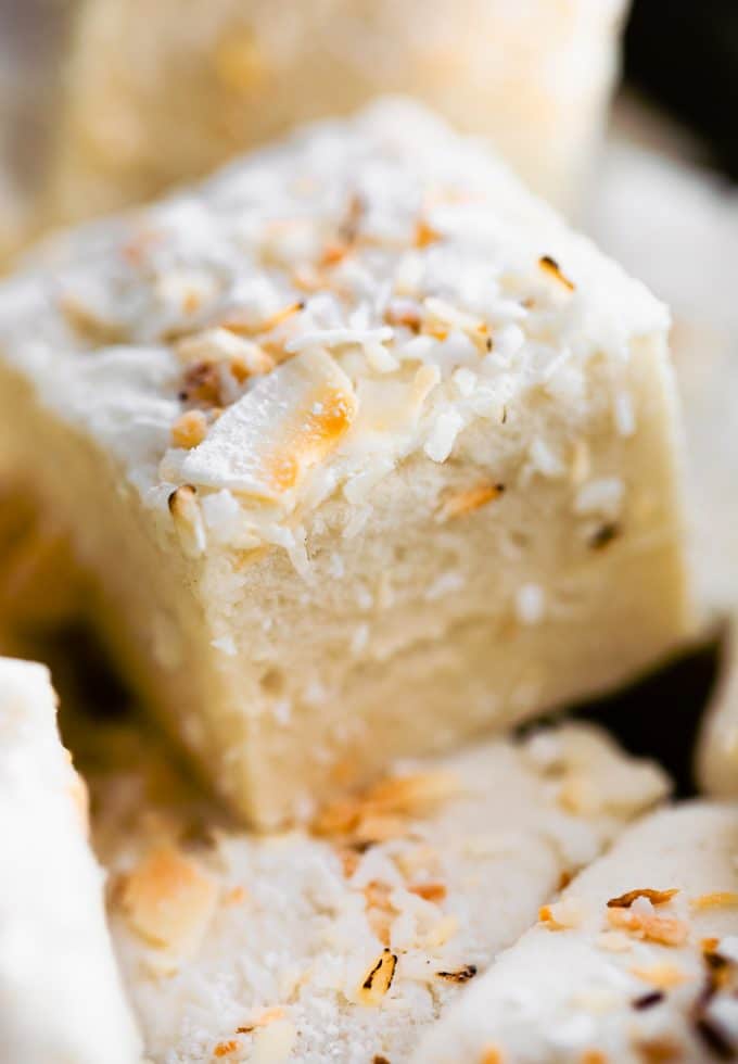 A close up image of homemade coconut marshmallows stacked.